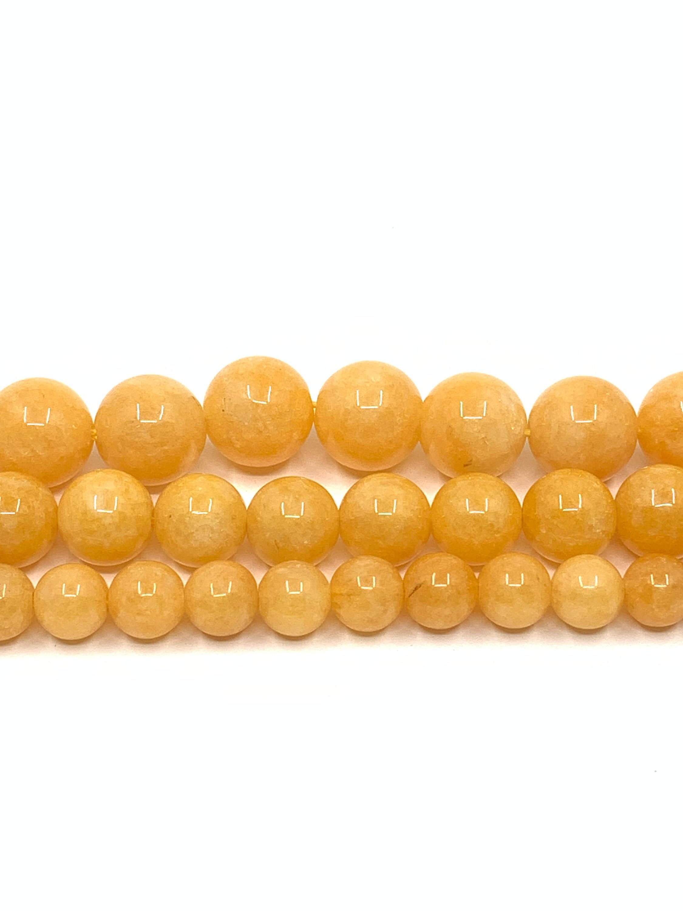 Milky yellow jade gemstone beads in full strand. 3 different sizes shown: 6mm, 8mm and 10mm