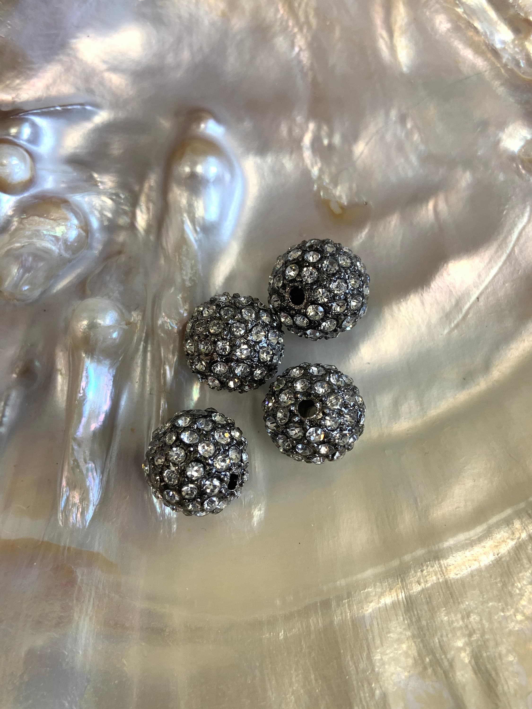 Gunmetal beads with clear rhinestones in alloy material.