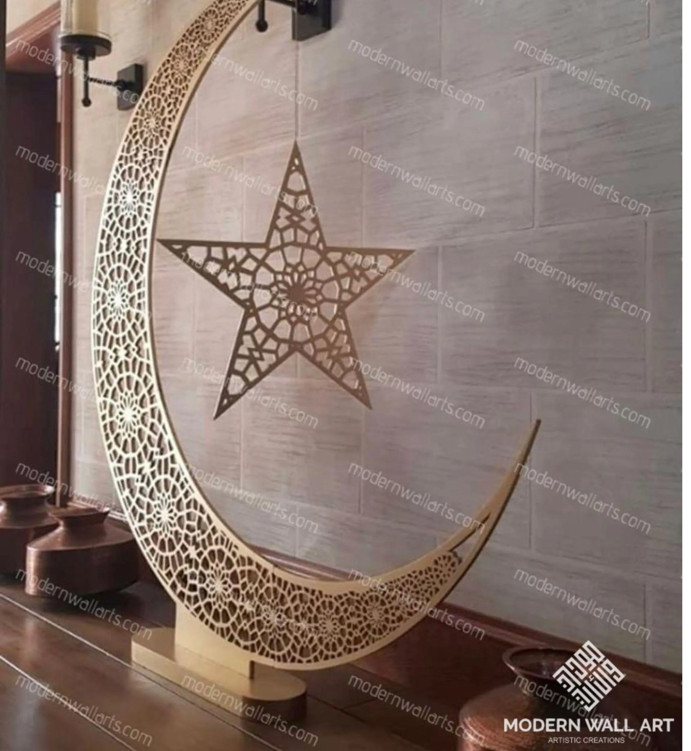 A large, freestanding golden crescent moon with intricate cut-out patterns, holding a matching star by a chain, stands on a flat base on a wooden surface.
