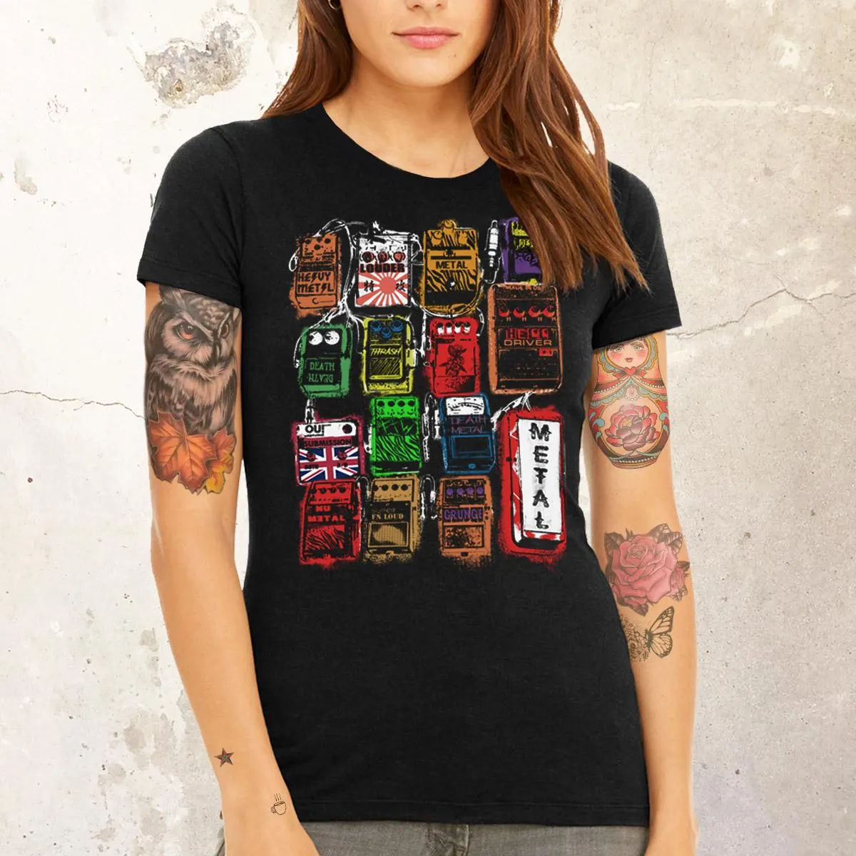 Flat lay of folded Distortion Pedal Tee with guitar picks and amp cord for musician lifestyle aesthetic