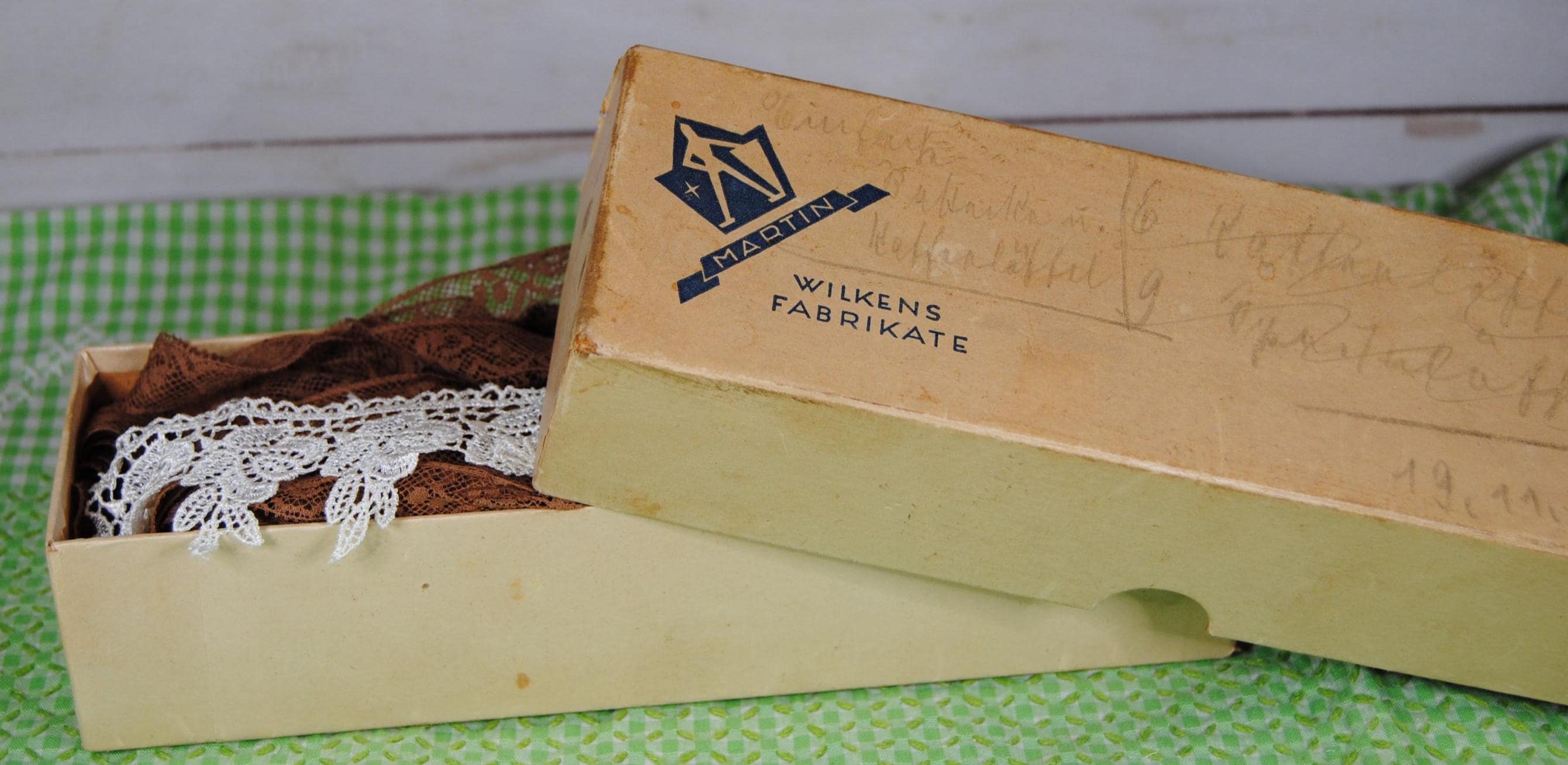 Vintage Wilkens Fabrikate box filled with buttons and trim - Browns and tan