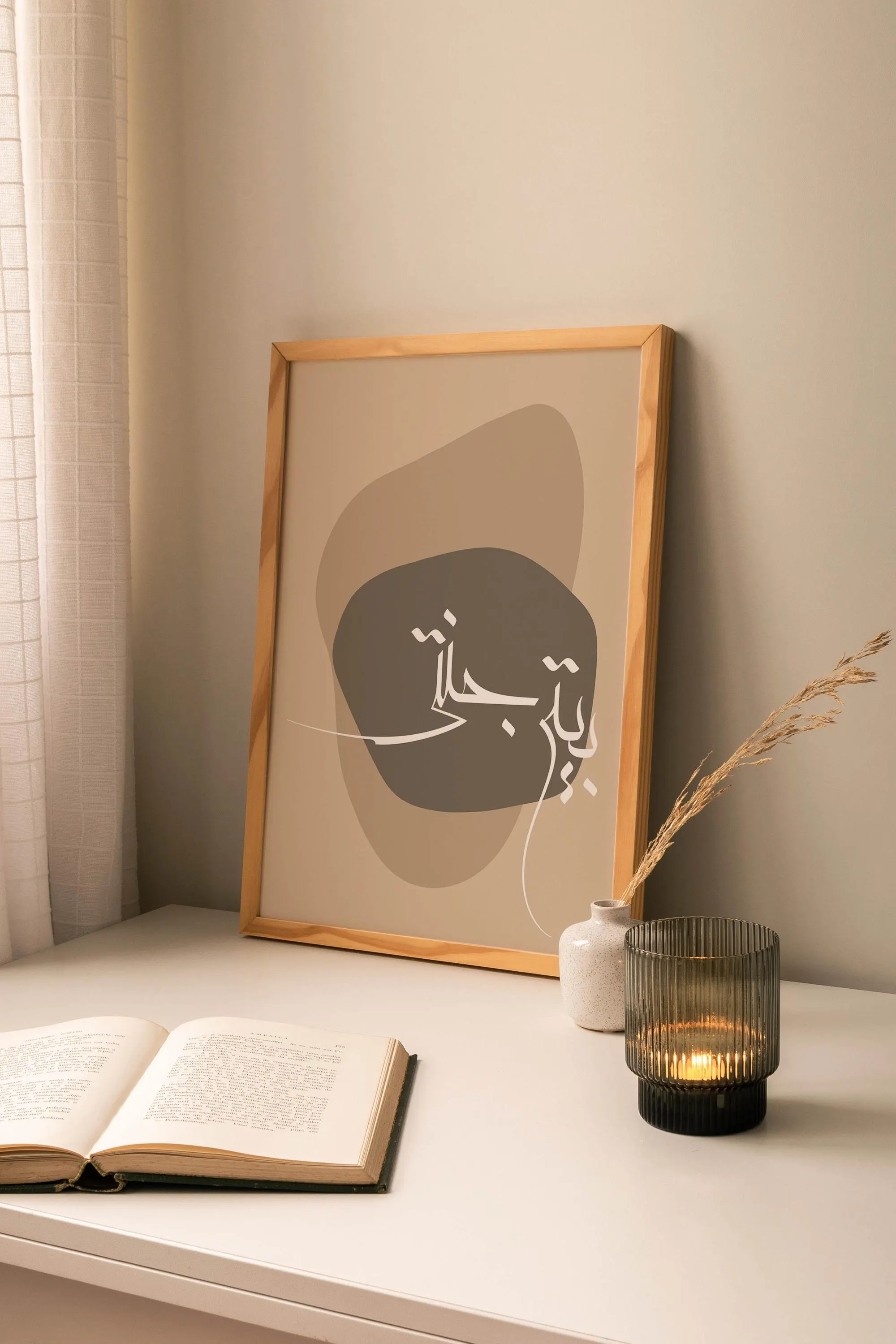 a picture of a book and a candle on a table