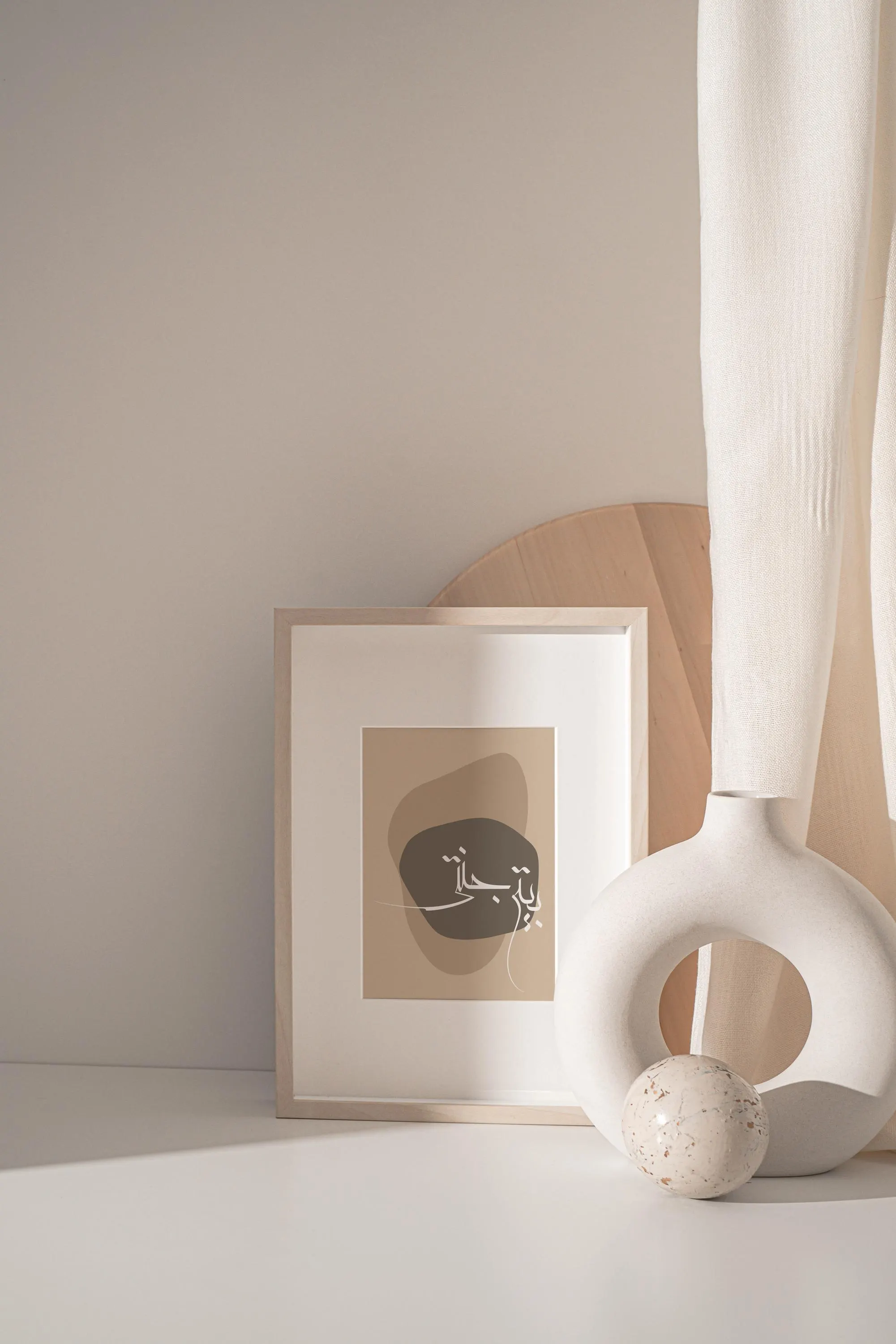 a white vase sitting next to a framed picture