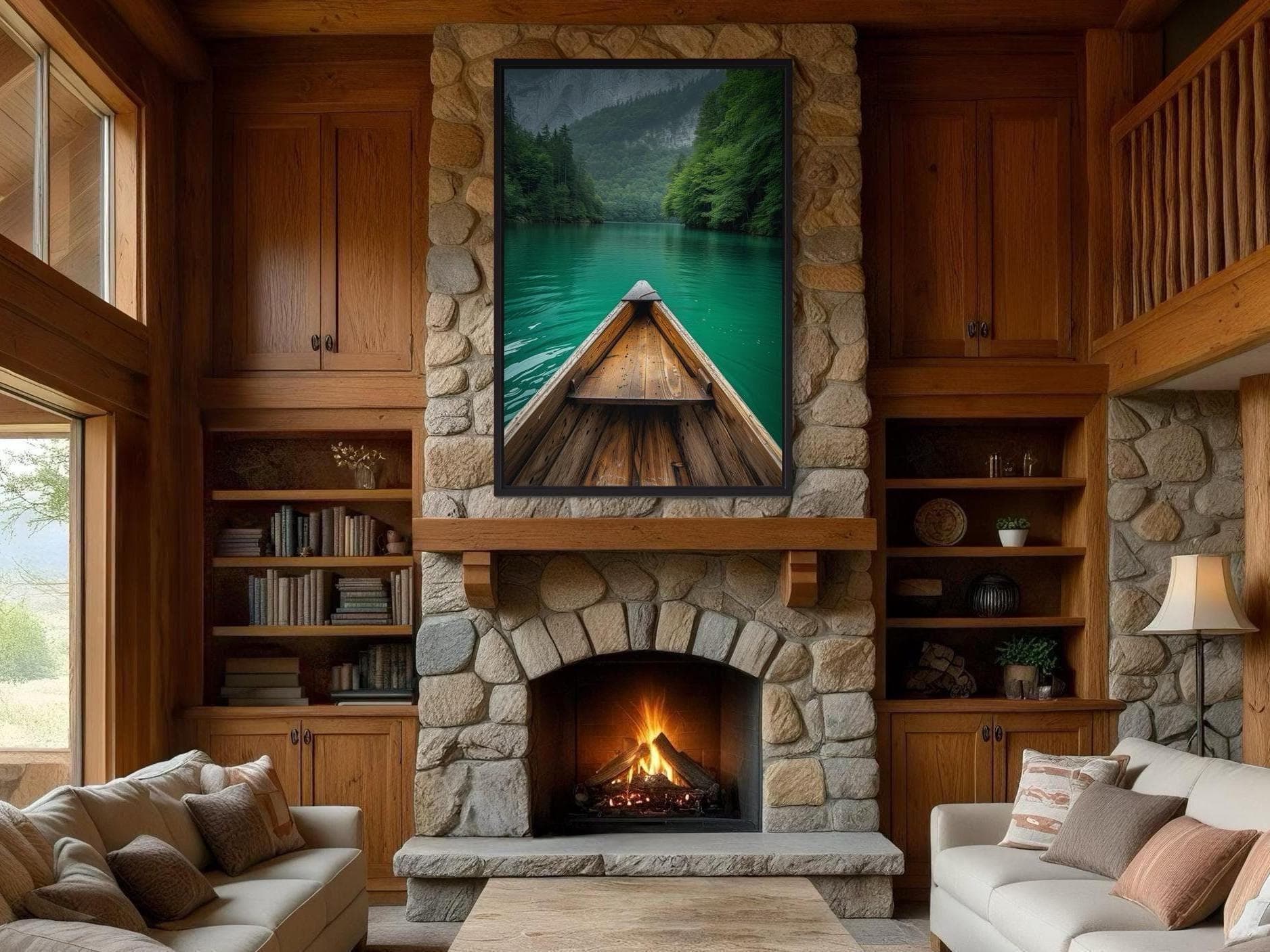 a cozy living room with a stone fireplace, a large painting of a boat on a lake, and a bookshelf filled with books. The room has wooden cabinets and a stone fireplace, creating a warm and inviting atmosphere.