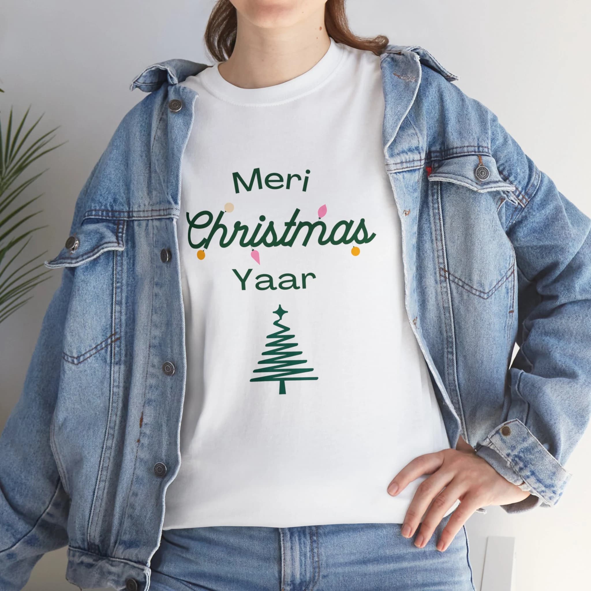 A unisex crewneck short sleeve t-shirt that says Meri Christmas Yaar above a lined Christmas tree. Option of white or sport gray. Option for express 2-day delivery expect Alaska or Hawaii.