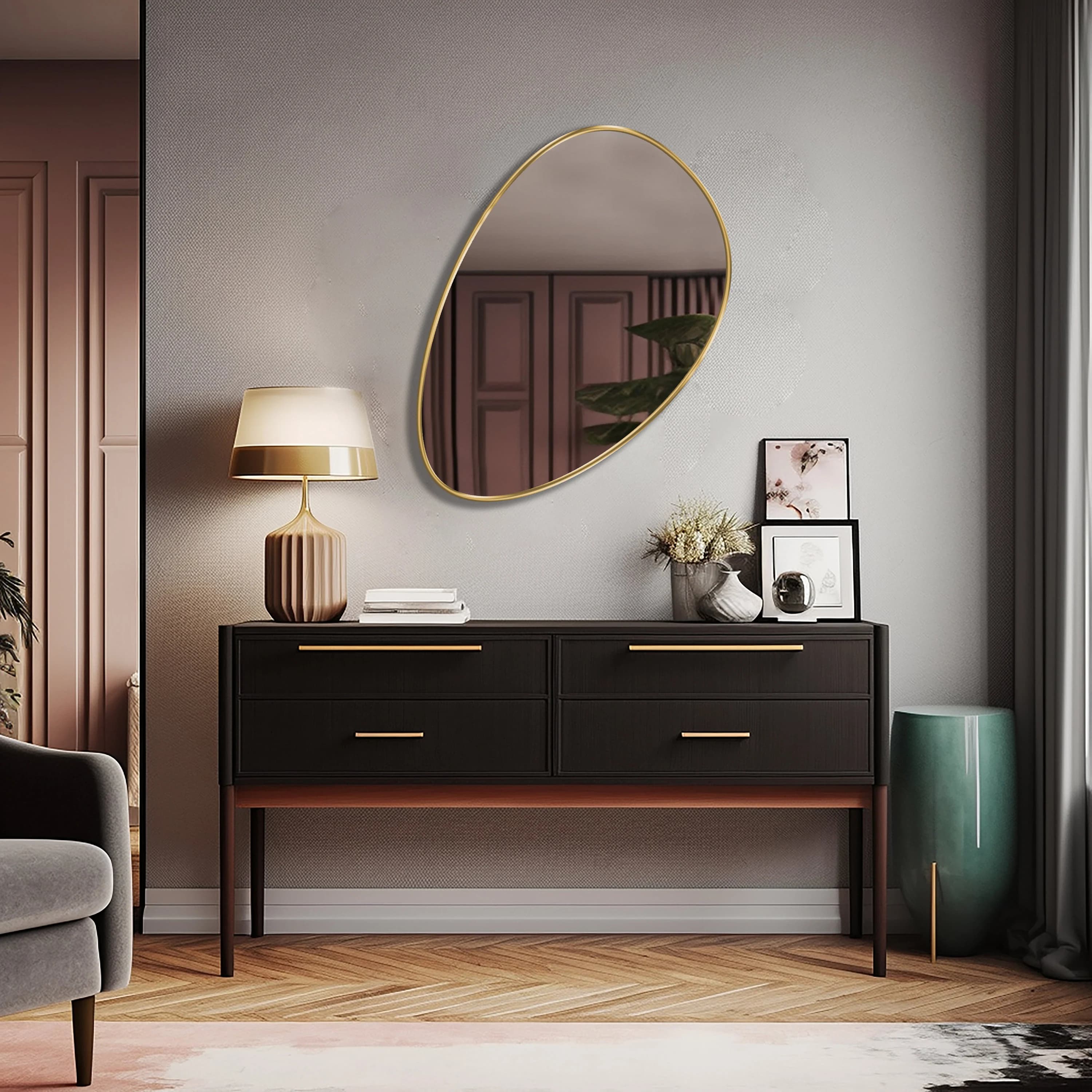 Egg shaped mirror with gold frame hung on the wall of a living room.