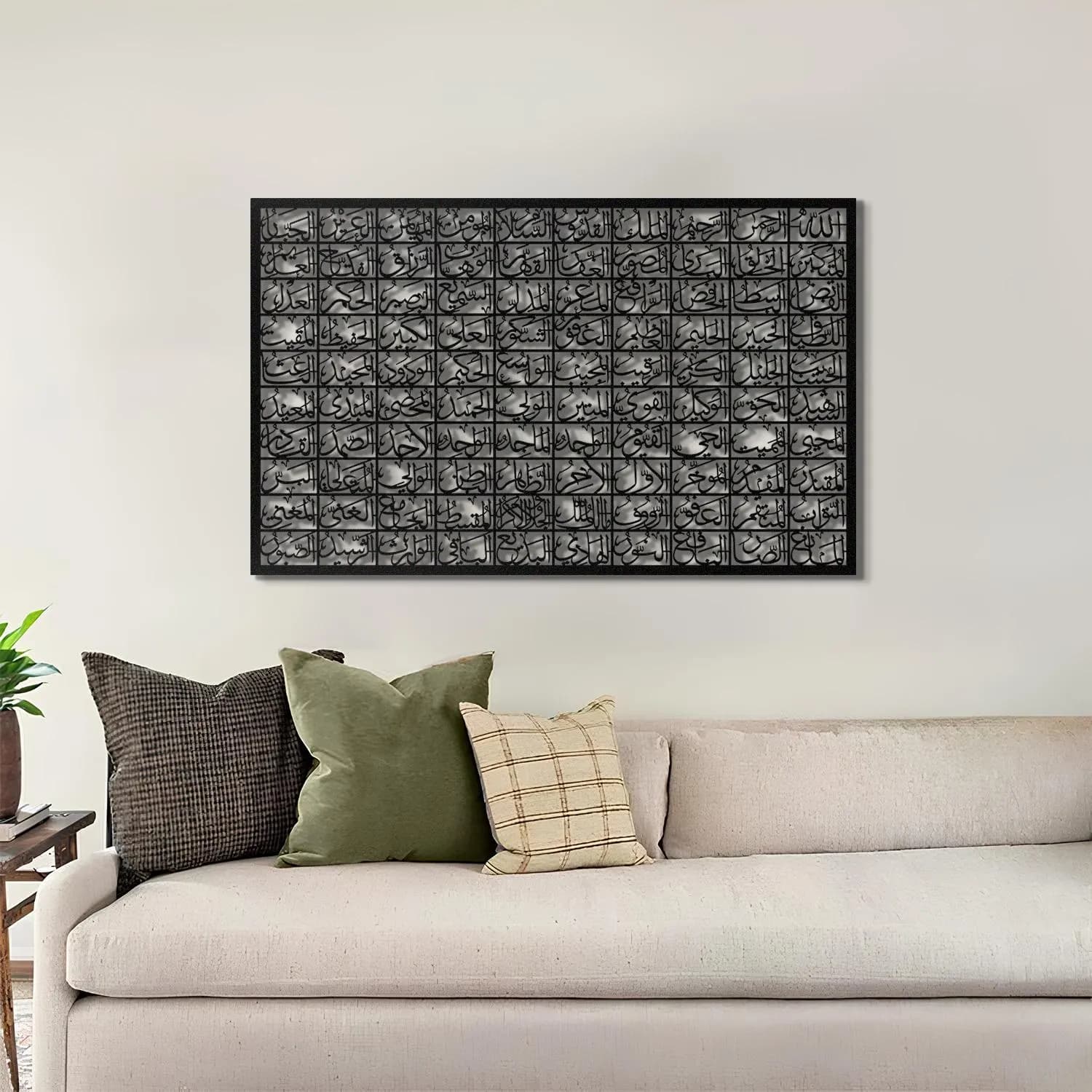 May include: Black and white abstract art print featuring a geometric pattern of repeating Arabic calligraphy. The print is framed and hanging on a white wall above a gray couch with pillows.