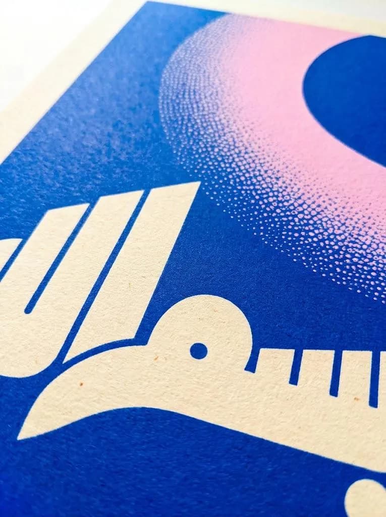 A screen print on textured off-white paper featuring a bold blue background. The design includes a large, soft purple gradient circle with a stippled texture and stylized cream-colored Arabic calligraphy with sharp lines.