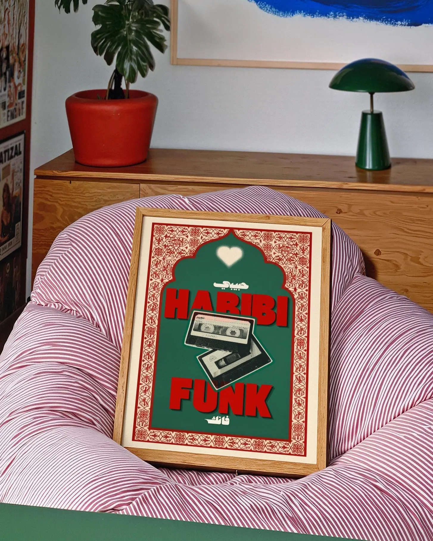 A framed rectangular poster featuring a dark green background with a red decorative border. The text HARIBI FUNK is printed in bold red letters, accompanied by two cassette tapes, a white heart icon, and Arabic script text.