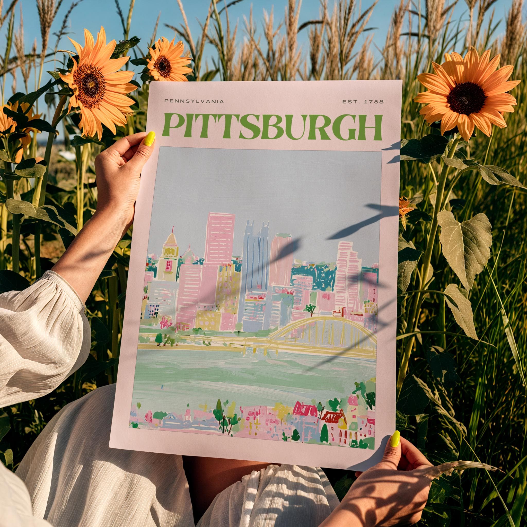 A rectangular art print featuring a stylized illustration of the Pittsburgh, Pennsylvania skyline. The print includes the text "PENNSYLVANIA" and "EST. 1758" above the green "PITTSBURGH" title, showcasing pink buildings and a yellow bridge.