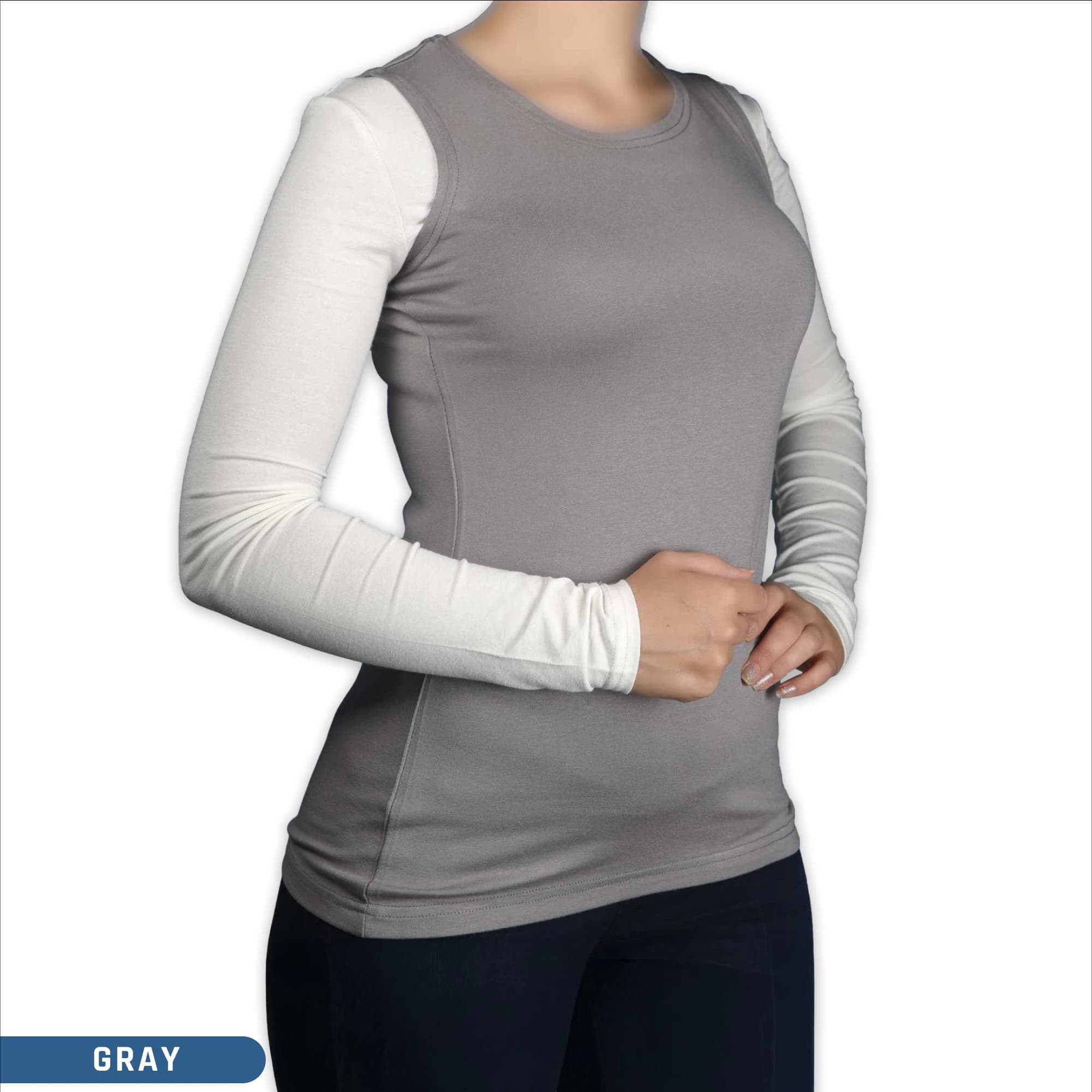 A woman wearing a sleeveless gray viscose crew neck body top ,a modest layering style for hijab clothing.