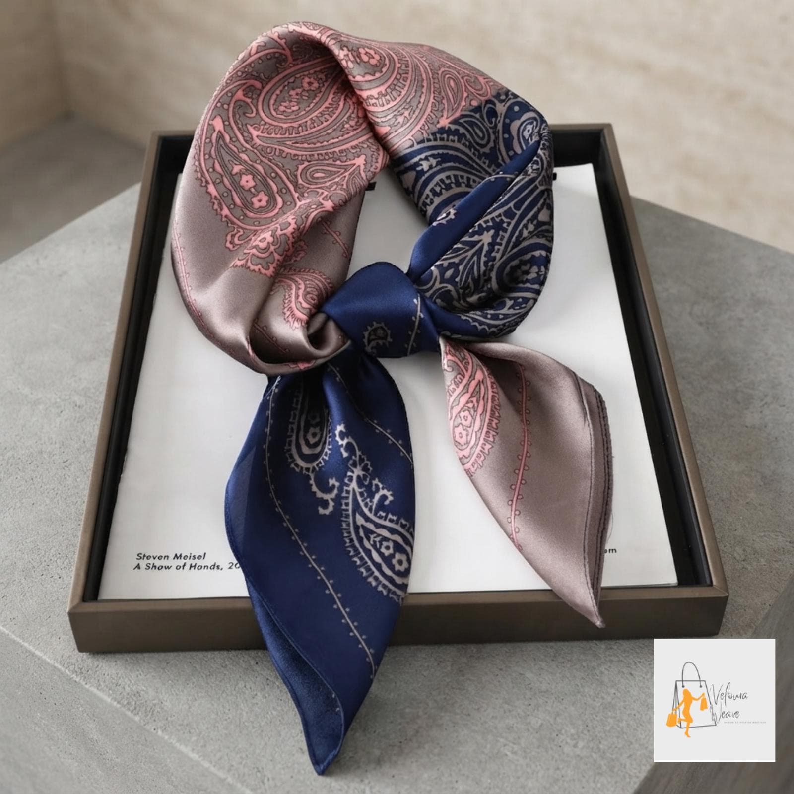 Lightweight satin scarf tied as a fashionable hair accessory.