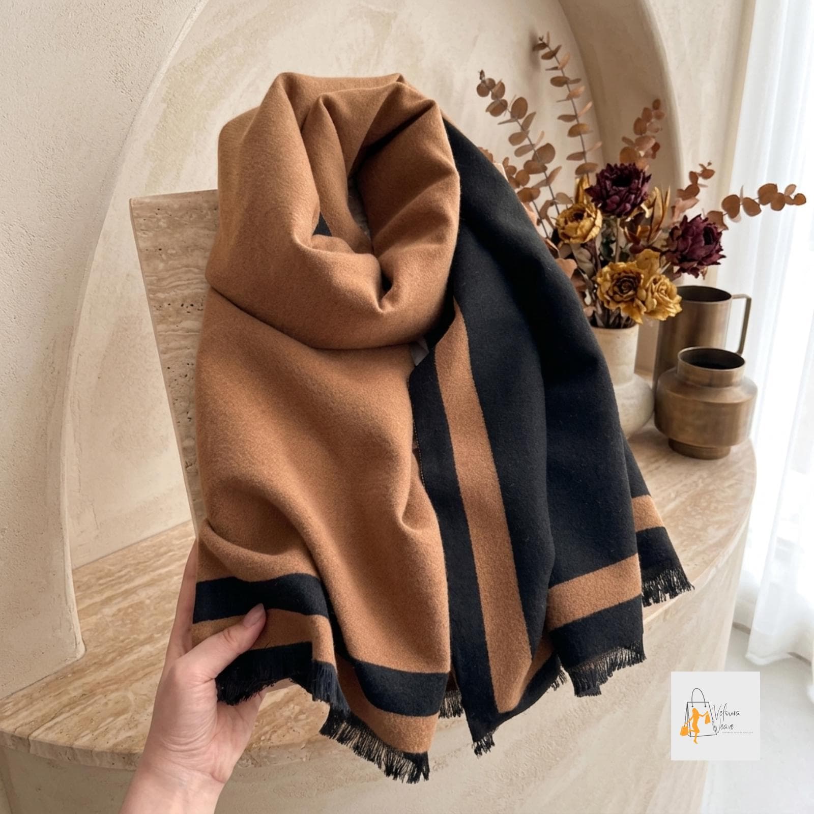 Plain-color scarf folded neatly on a wooden surface