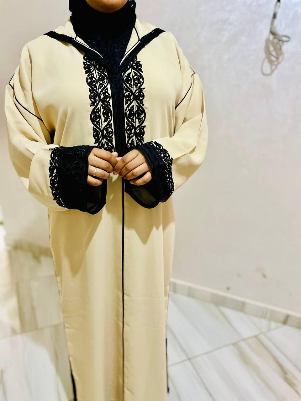 Beige handmade Moroccan djellaba with black decorative trim, modest traditional women's dress