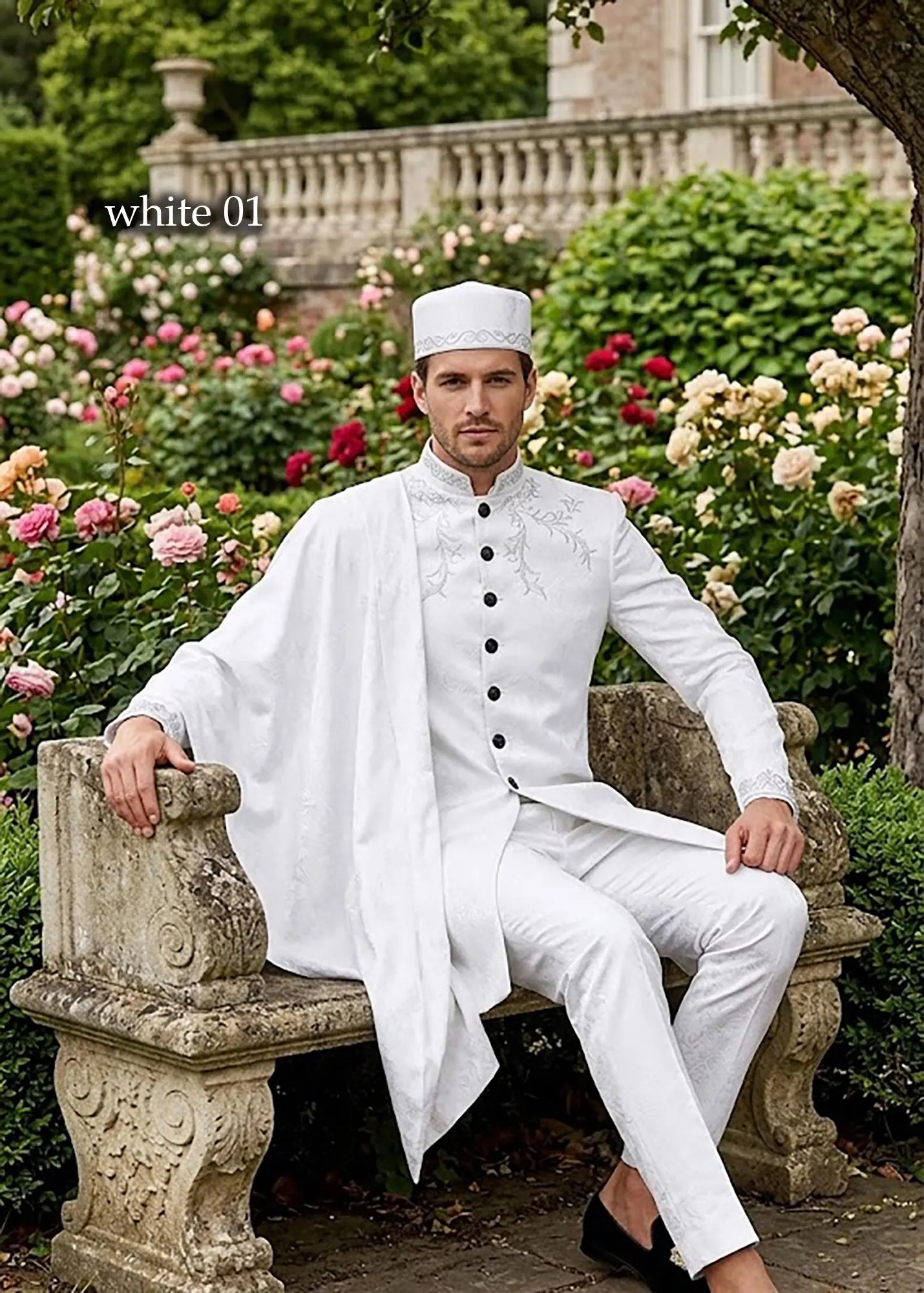 A man wearing a sophisticated burgundy 3-piece formal suit with intricate gold embroidery on the chest and cuffs, displayed in a professional setting