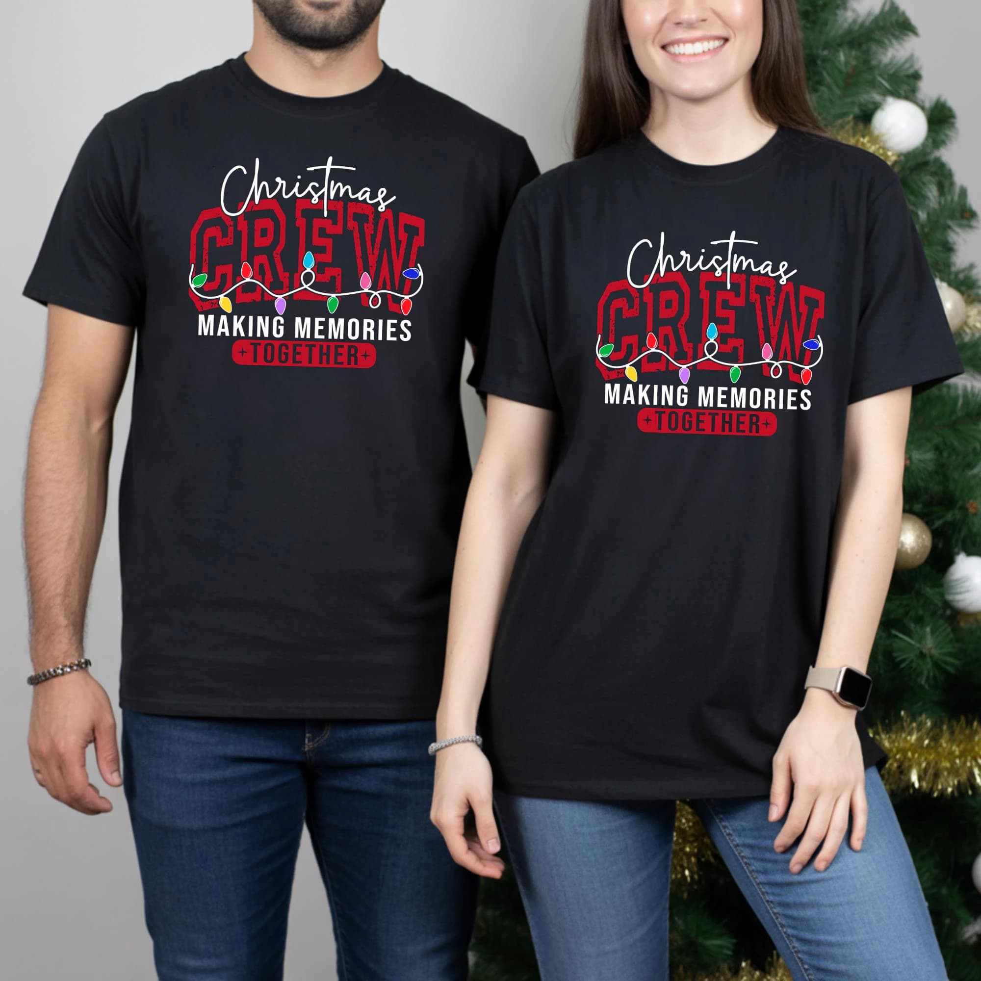 A man and a woman are standing next to each other, both wearing black t-shirts with Christmas-themed text and graphics.