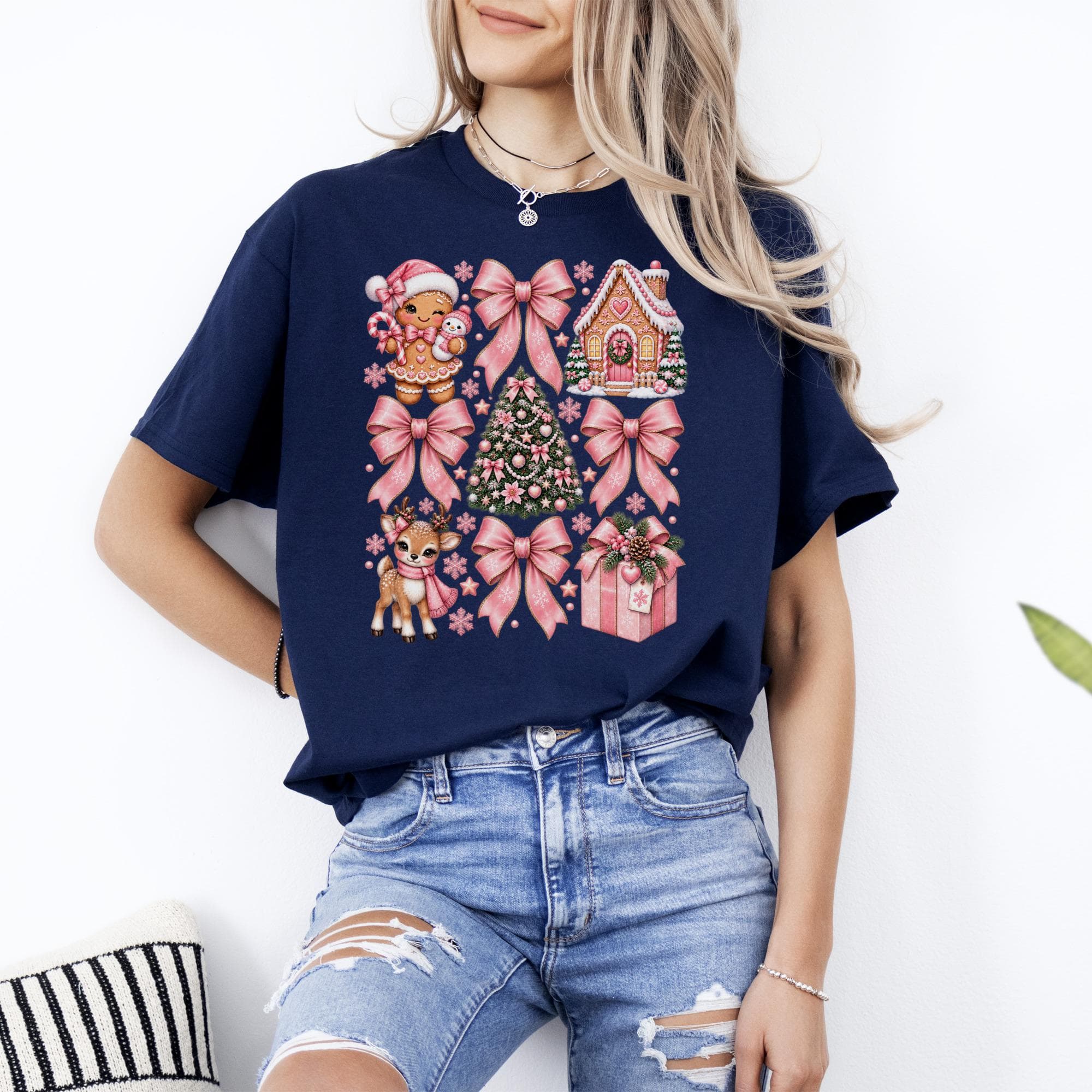 Navy t-shirt with a repeated pattern of gingerbread man, reindeer, Christmas tree, and gifts.