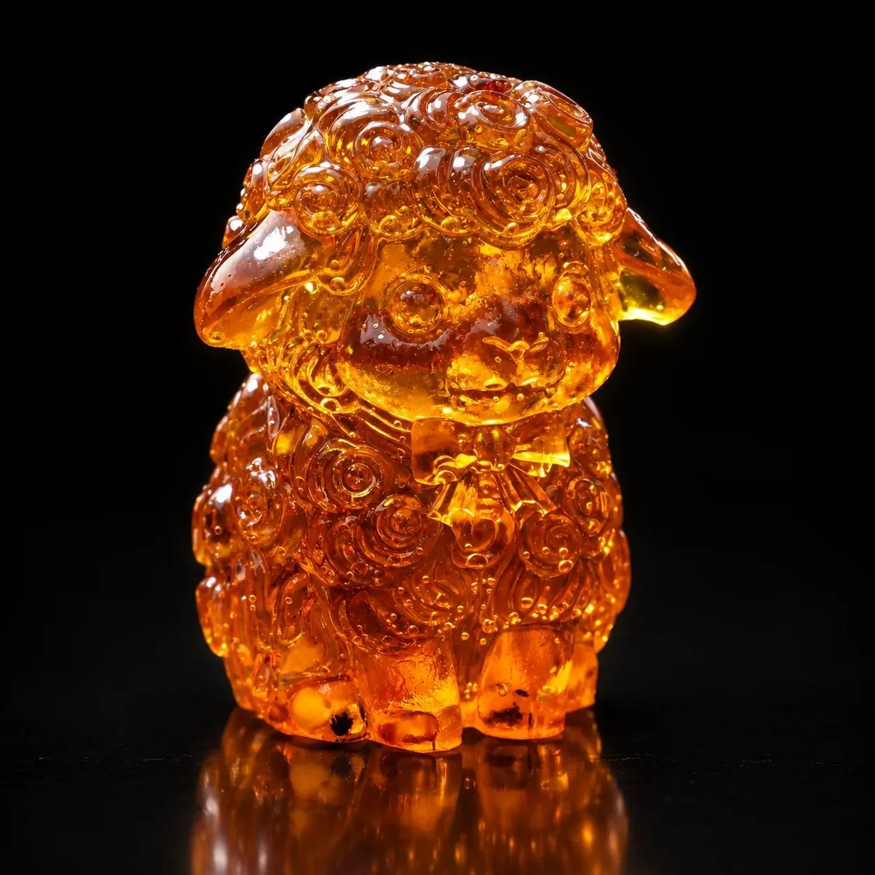 Made in USA Natural Baltic Amber sheep figurine in deep honey tone by KIZIMA® on a black studio backdrop, Christmas and New Year 2027 gift