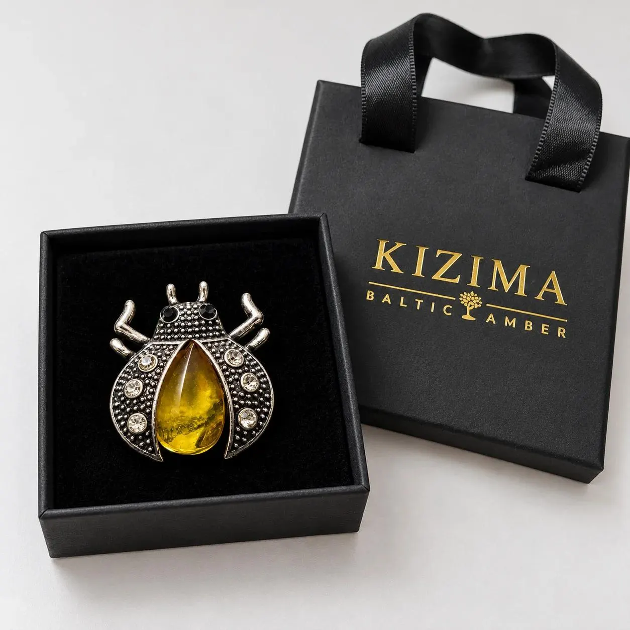 KIZIMA yellow honey amber beetle brooch 20-301Q5-2-2-1, with actual KIZIMA gift packaging.