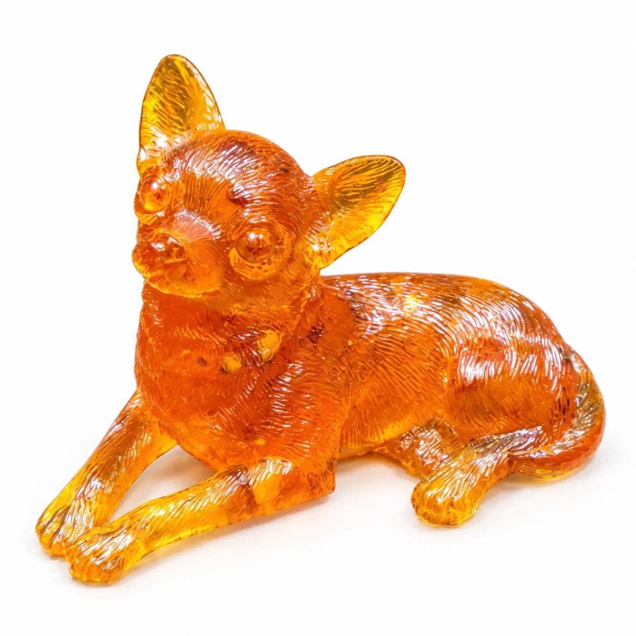 Natural Baltic amber Chihuahua lying down sculpture with large upright ears and carved fur on a white background, KIZIMA.