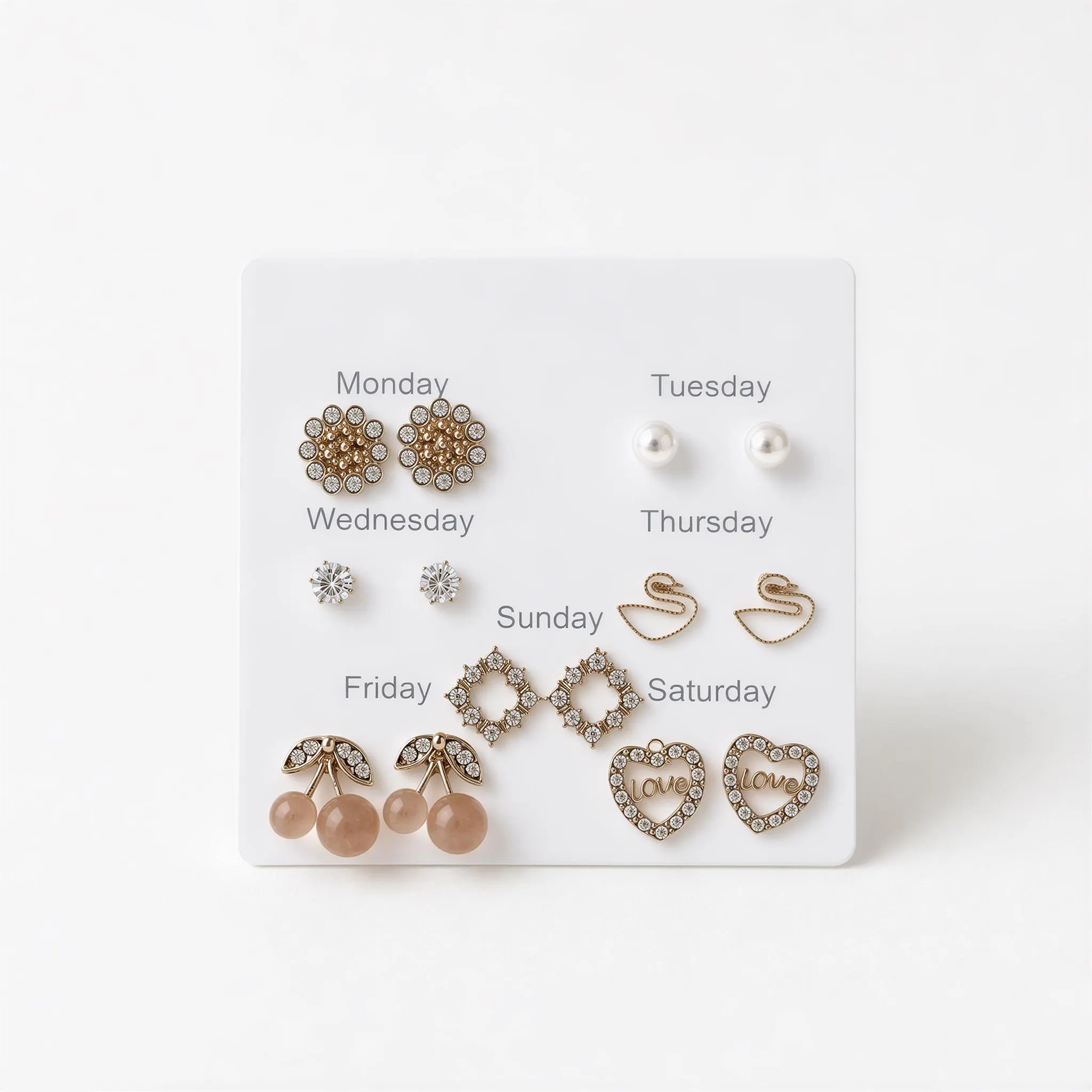 A collection of earrings with various designs, each representing a different day of the week.