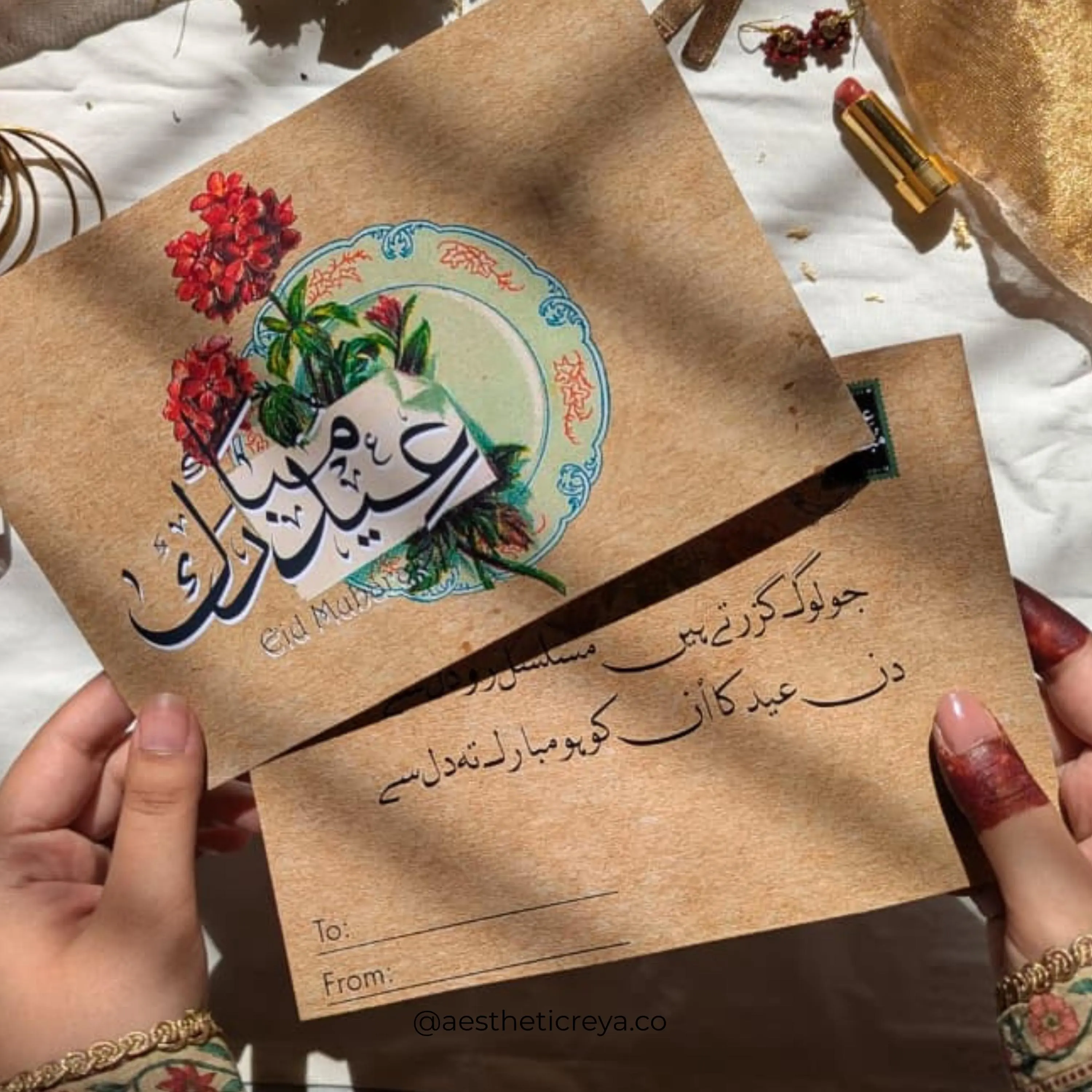 Flatlay of Islamic greeting card with red floral botanical and Arabic script