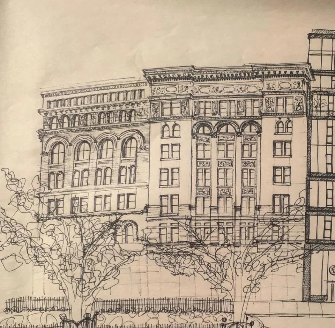 Pen and ink architectural drawing of a building with ornate details, arched windows, and a decorative cornice. Pen and ink on sketch paper.