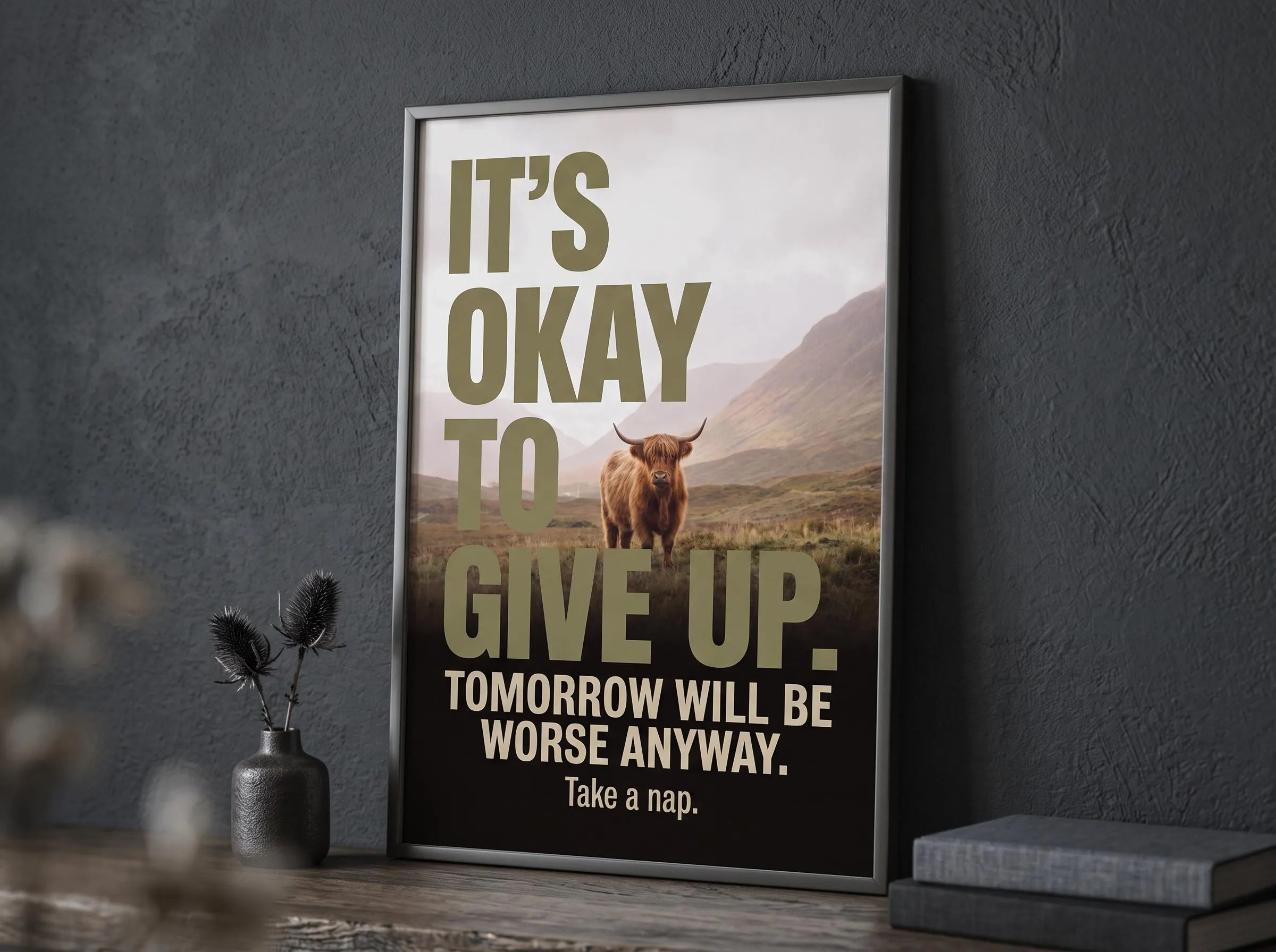 Above bed decor dark humor typography print showing a Highland cow in fog-shrouded Scottish highlands. Large olive-gold letters deliver a nihilist take on productivity. A demotivational gifts landscape print with cinematic contrast and sardonic charm.