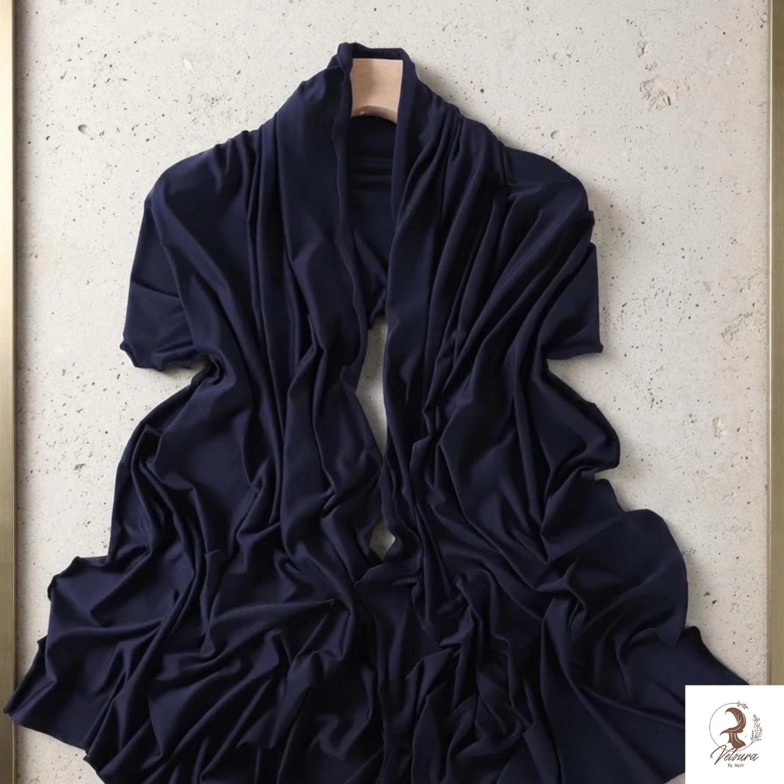 Solid-color jersey hijab featuring a softly curved wavy edge.
