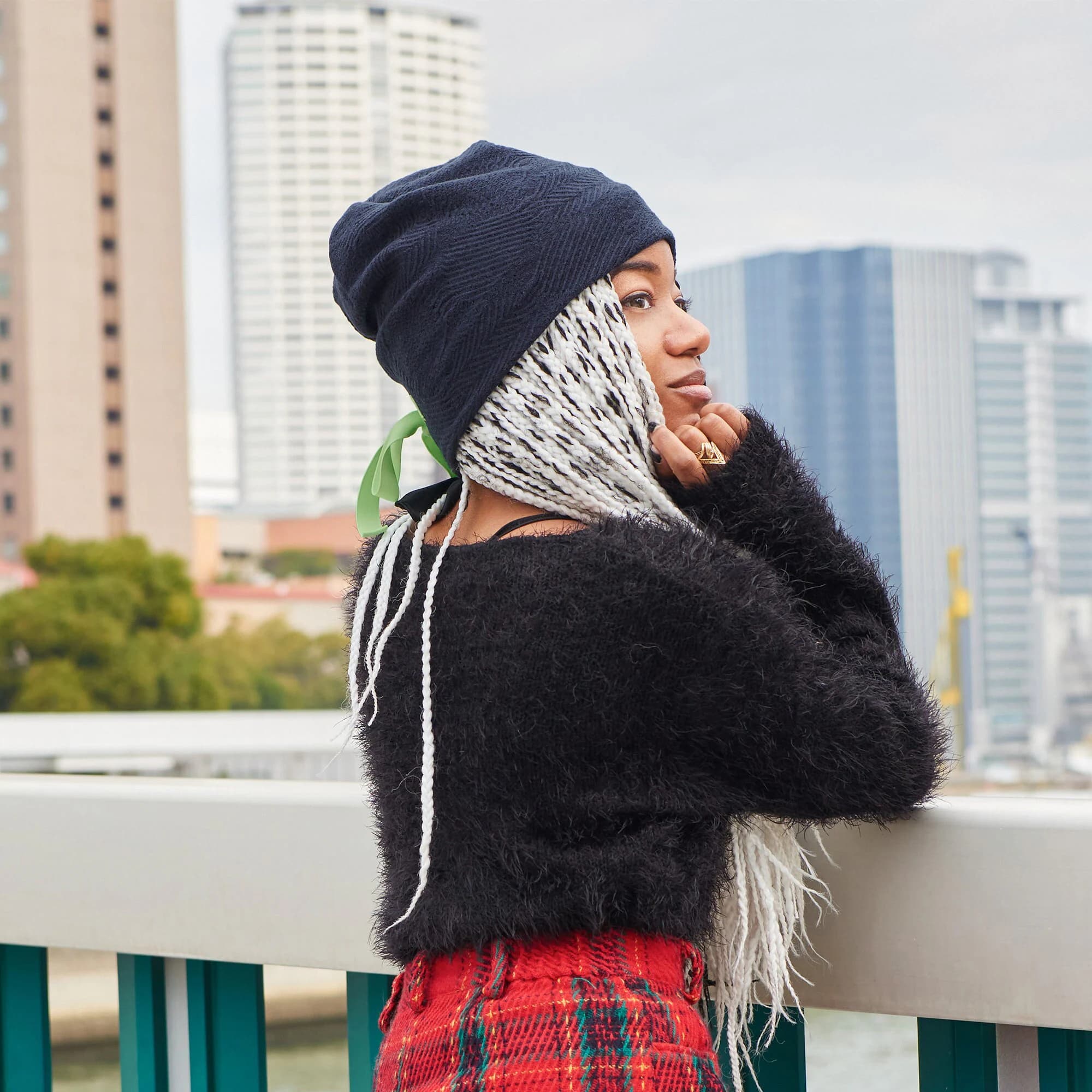 African American Female Model wwearingith white and black hair wearing textured navy cotton lined slouchy beanie with a green ribbon for winter and autumn